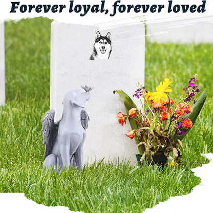Pet memorial statue beside flowers and a remembrance marker