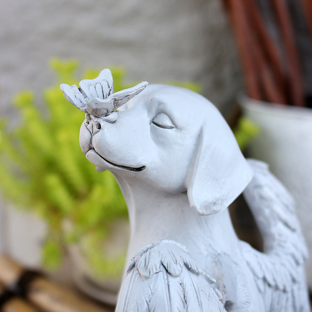 Close-up of the dog statue with a butterfly on its nose