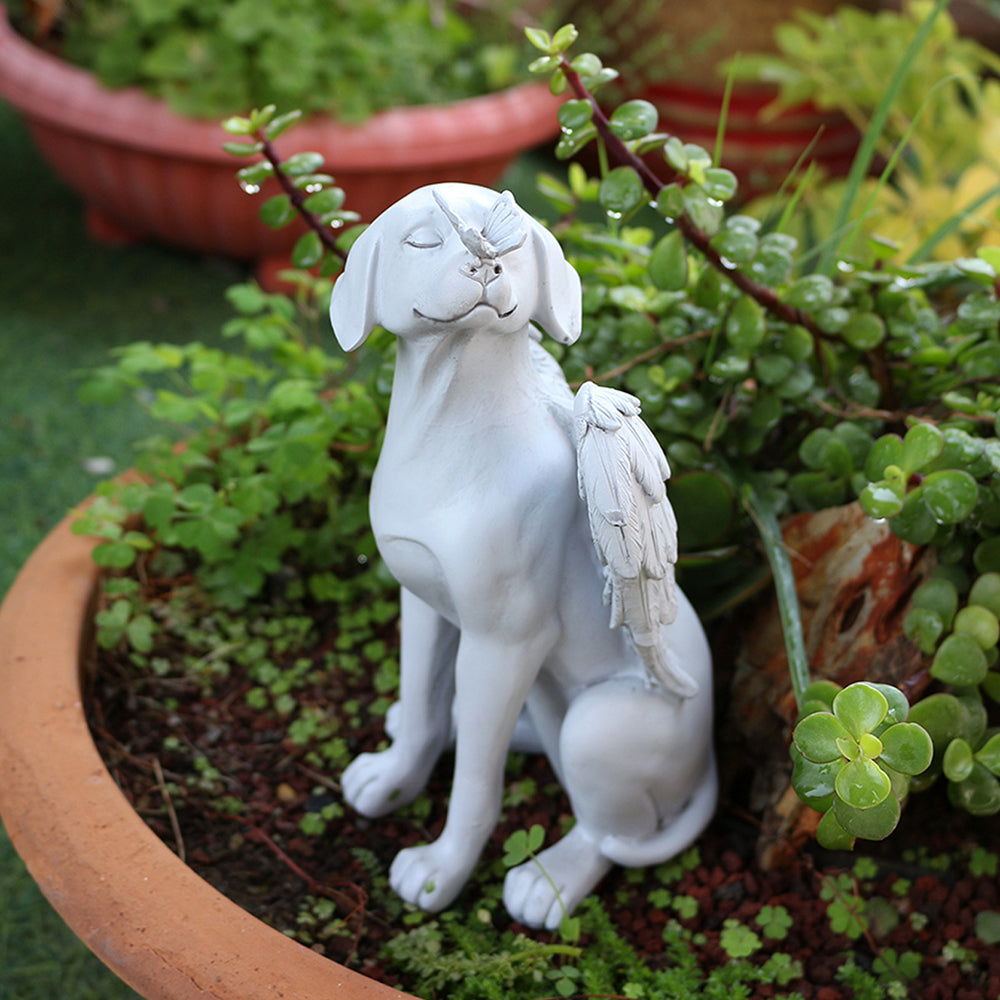 Angel dog remembrance statue in a garden planter
